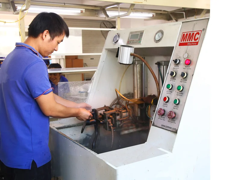 FAAO factory technician testing faucet components on MMC machine for ACS certified production