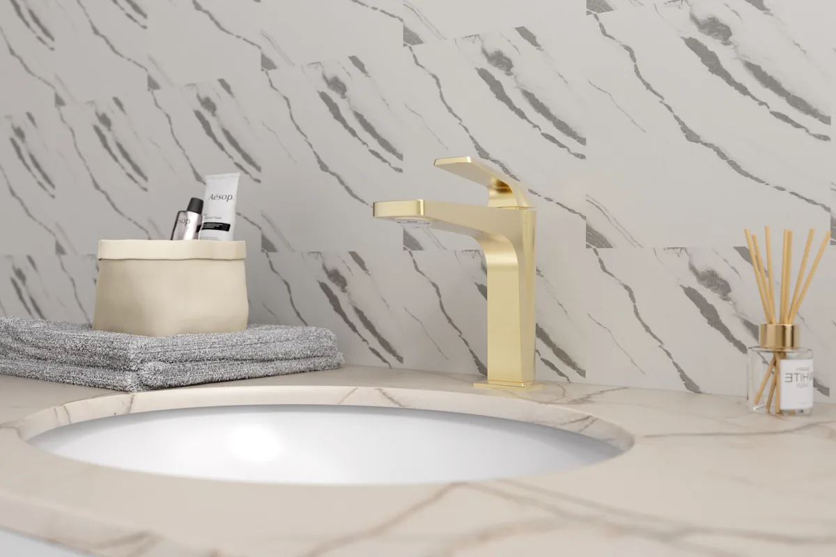 Brushed gold deck-mounted single-hole basin faucet installed on a marble countertop